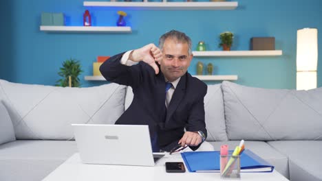 Home-office-worker-man-making-negative-gesture-at-camera.
